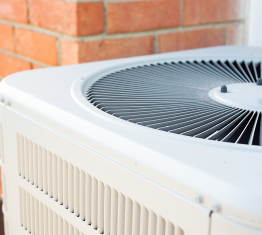 A close up image of an air conditioner. This image introduces a blog about winter AC maintenance tips to ensure performance come summertime.