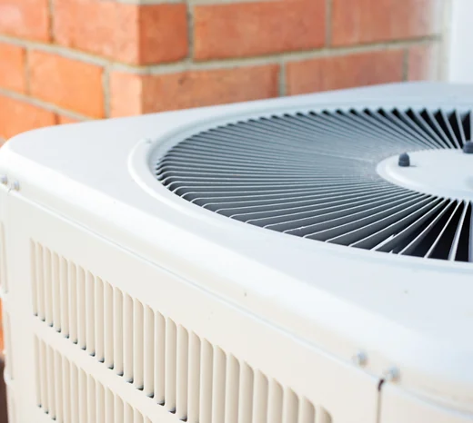 A close up image of an air conditioner. This image introduces a blog about winter AC maintenance tips to ensure performance come summertime.